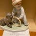 Figurine of young boy playing with his dog and a hoop