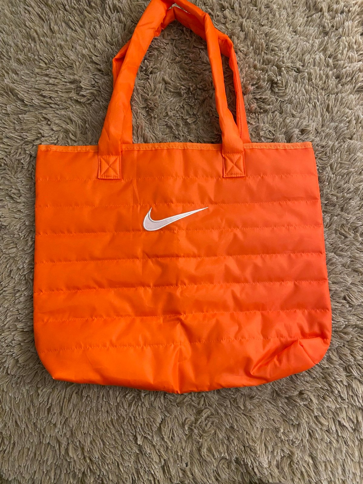 Nike tote bag (2024) in orange, big swoosh, puffer style