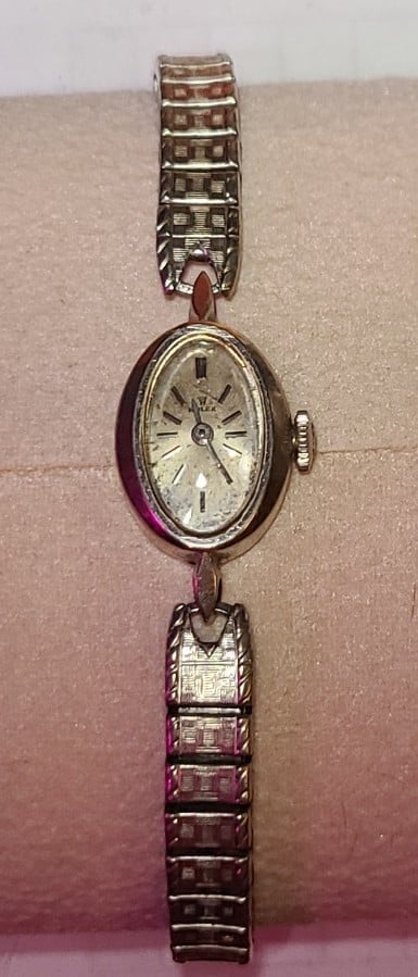 Rolex ladies 14k small oval cocktail watch in working order. Needs a cleaning.