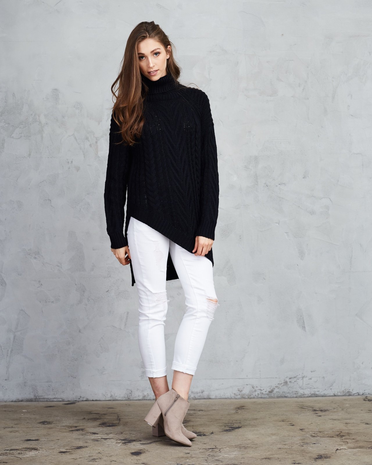 Asymmetric, black turtleneck.