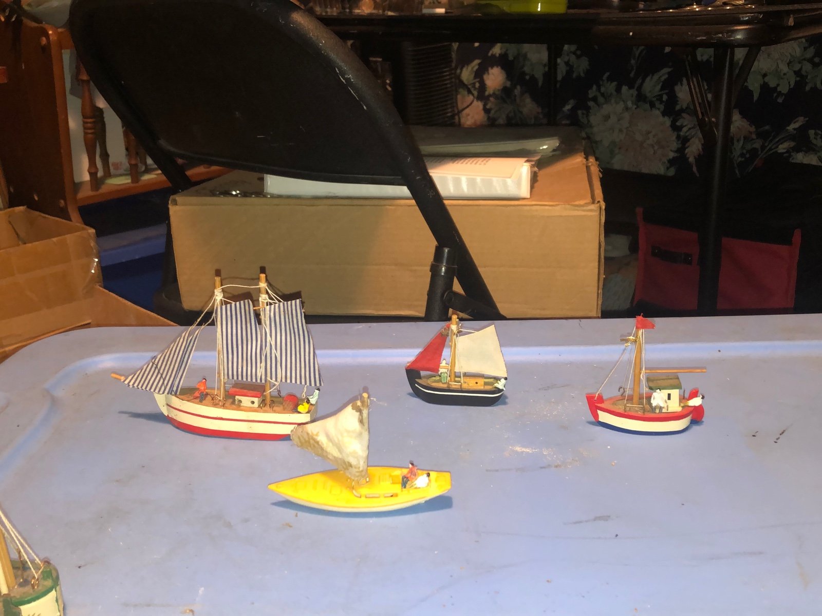 4 sailboats with people on board