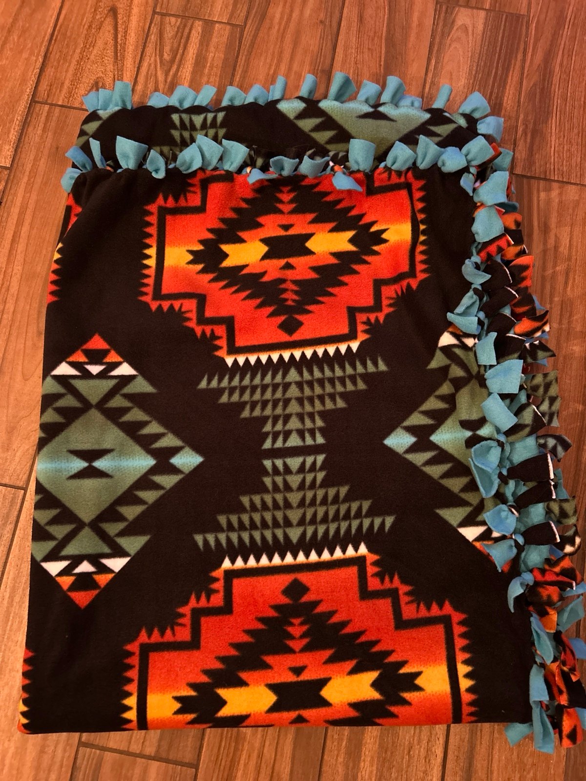 Southwestern Print w/Turquoise on back. 72 x 60, drapes a queen. No sew blanket
