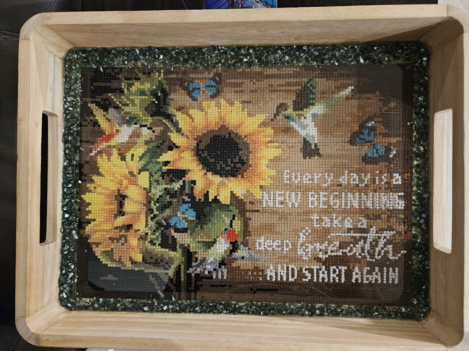 Dot diamond painting set in resin in a wood tray.