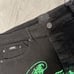 Mackeen Mens Black Flat Front Chrome Green Stud Distress Jeans Pant Size 38 NWT