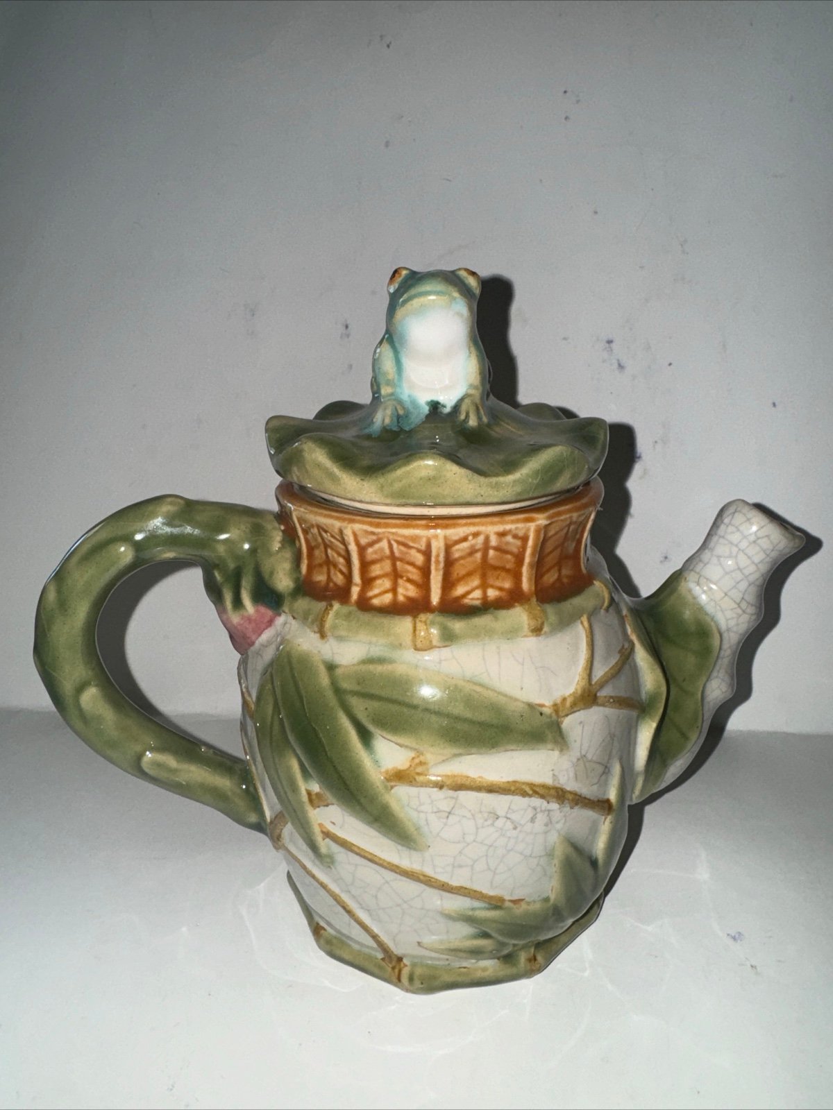 Vintage antique Japanese magolica teapot with frig on top