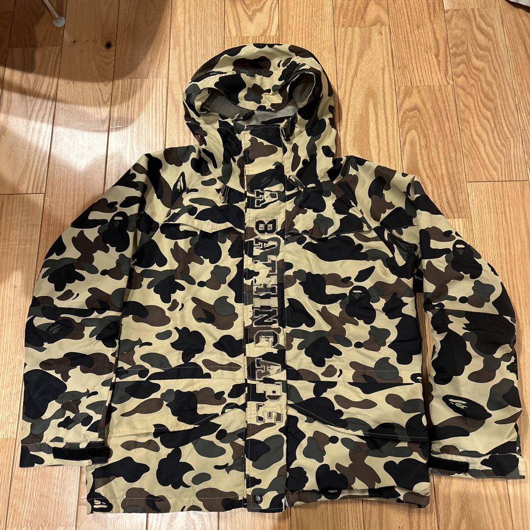 A Bathing Ape snowboard jacket, size L, yellow camo, 90s.