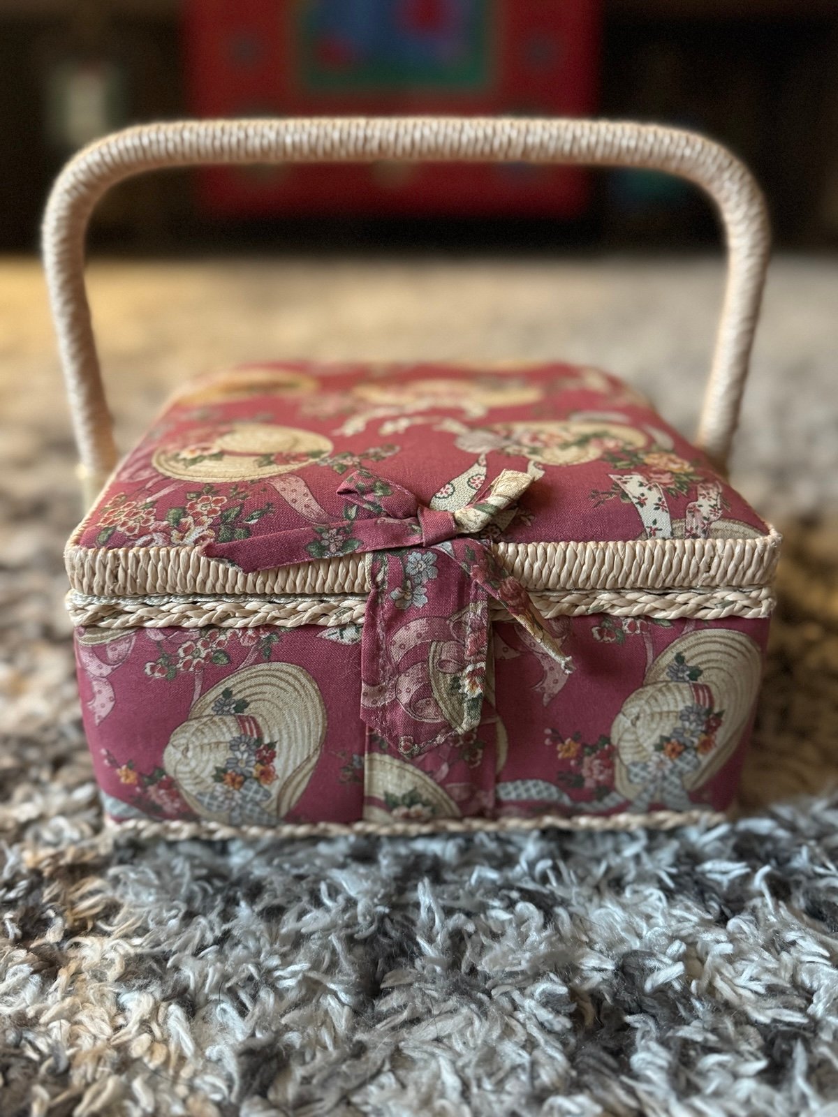 Vintage padded fabric covered sewing basket with a floral hat print