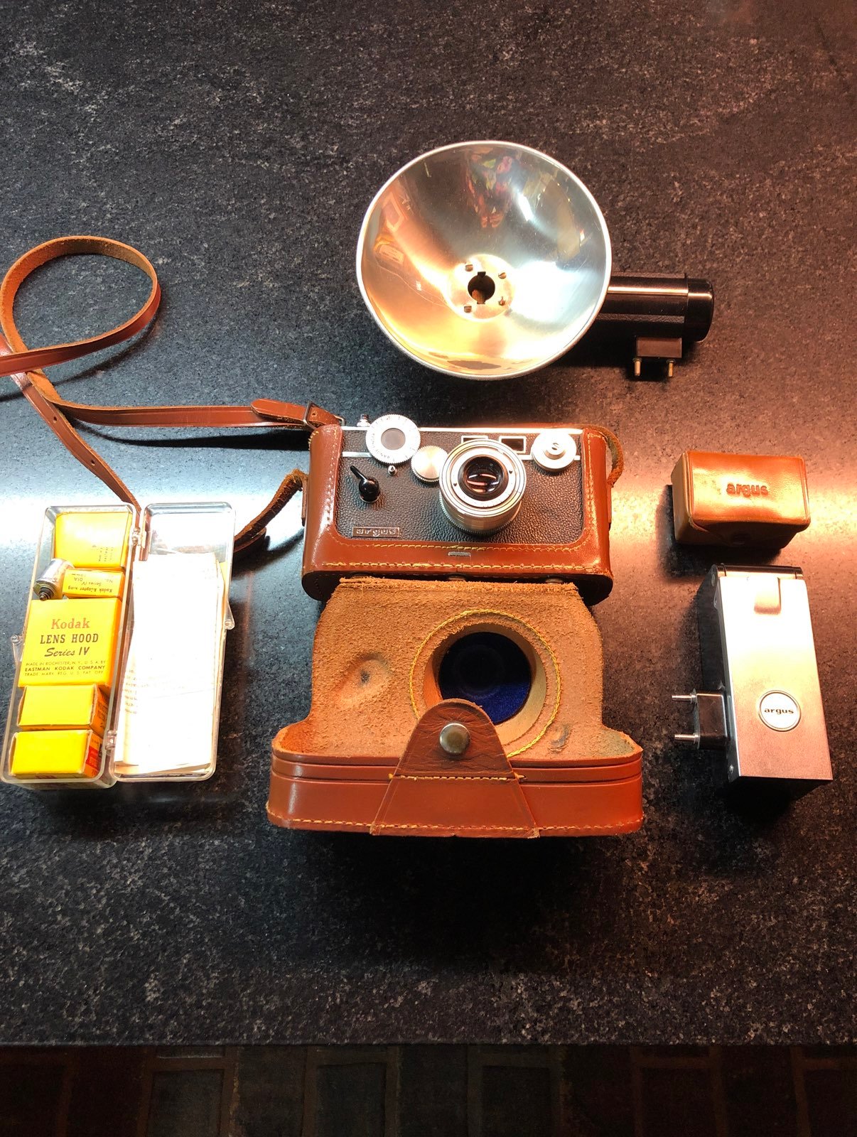 Antique Argus camera with light meter, flash boxes and filters