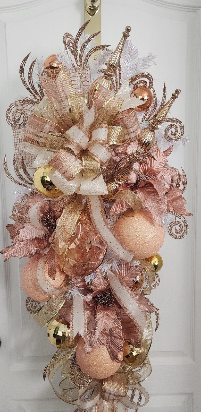 Peach Christmas Swag on a White Base with Pink Poinsettia and Gem.
