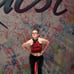 Red and black custom dance costume with rhinestones and fringe.