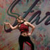 Red and black custom dance costume with rhinestones and fringe.