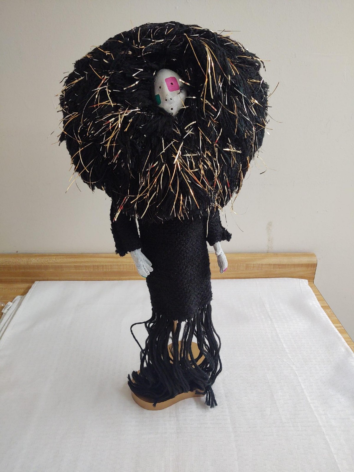 Large hand made doll; yarn/pottery face and hands.