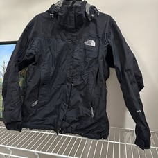 The black and grey The north face women's skip jacket