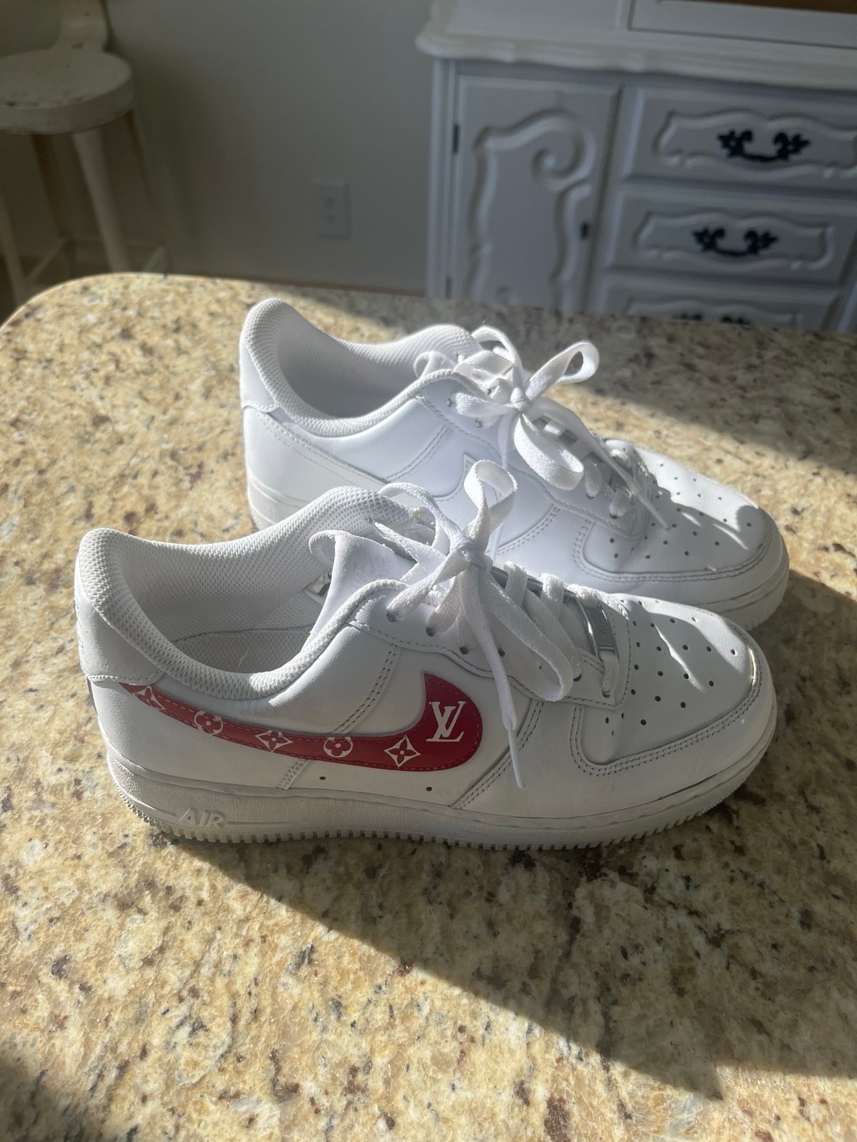 Stylish Nike Air Force sneakers. White base with red accents.