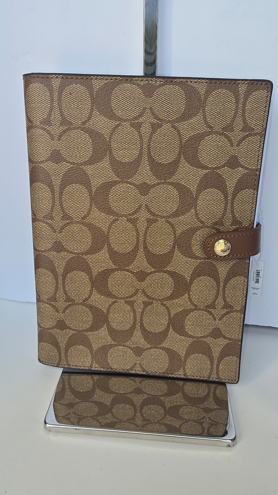 Coach Signature Canvas Notebook, with brown leather details.