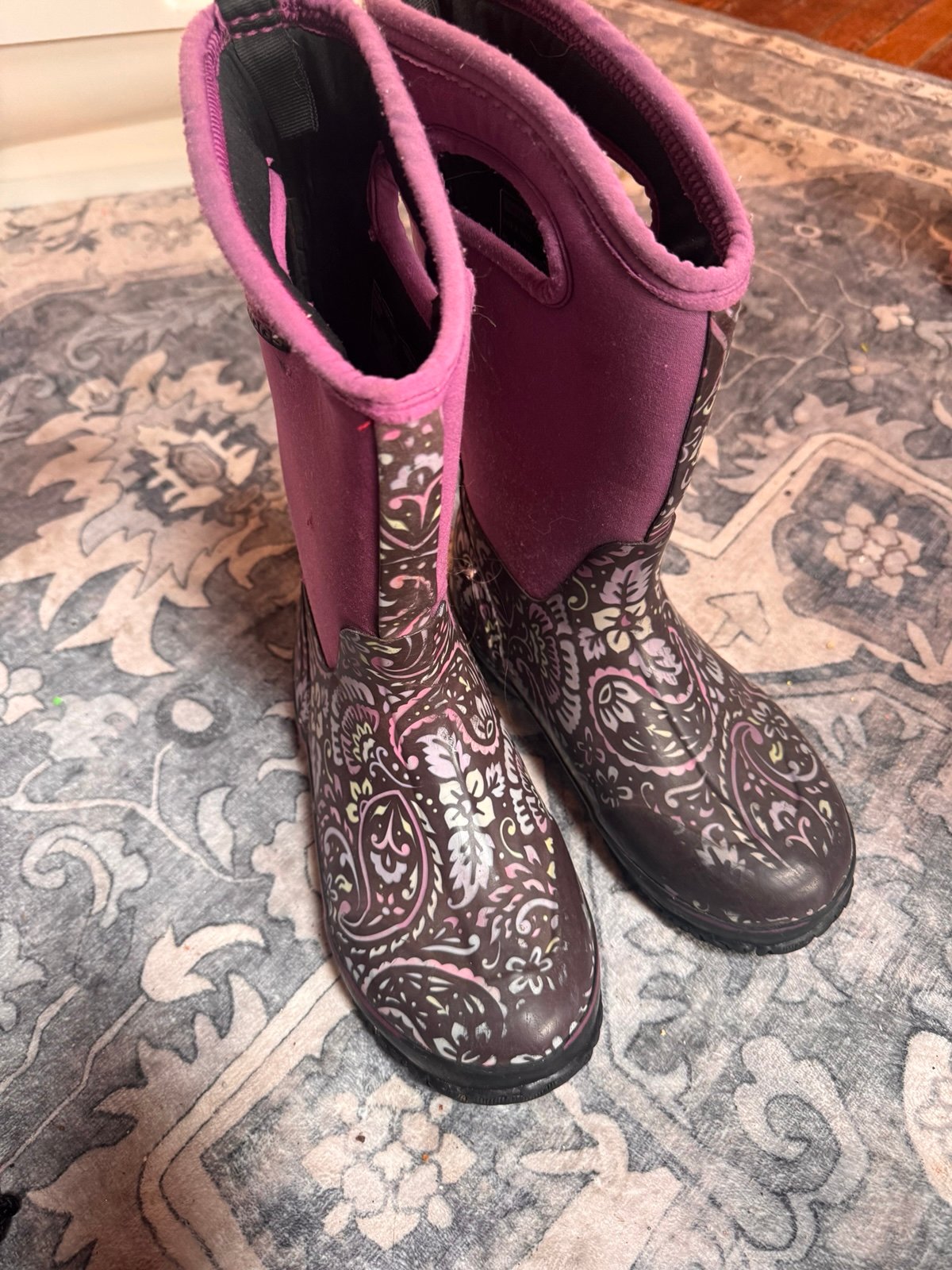 Stylish Bogs boots in purple with a black and white floral pattern. Perfect for