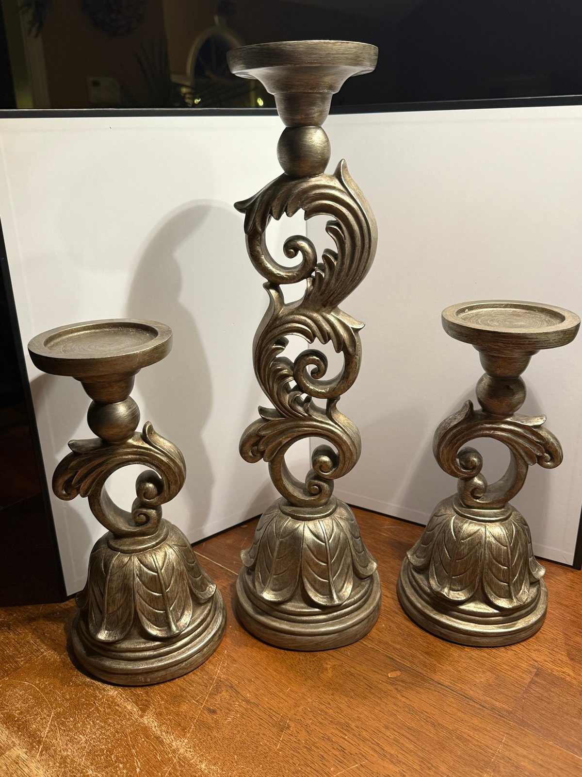 3 resin scrolled candlesticks with a leaf design base in a gold tone