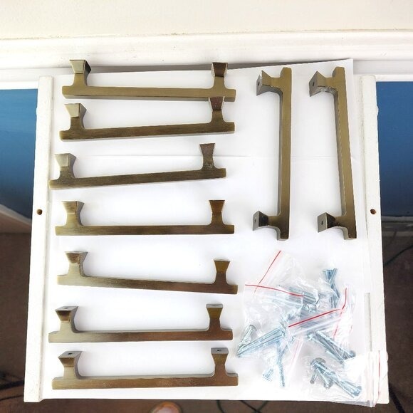 Lot of Nine Antiqued Gold Drawer Pulls