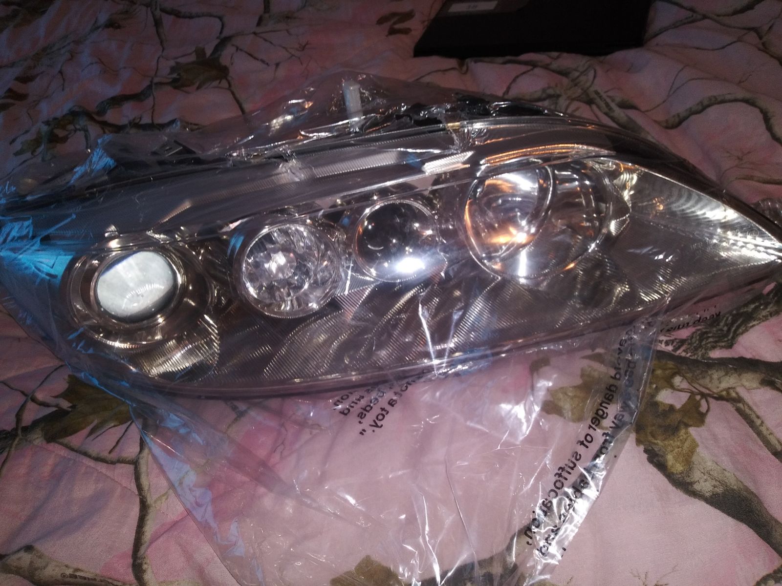 Complete headlamp assembly for a mazda