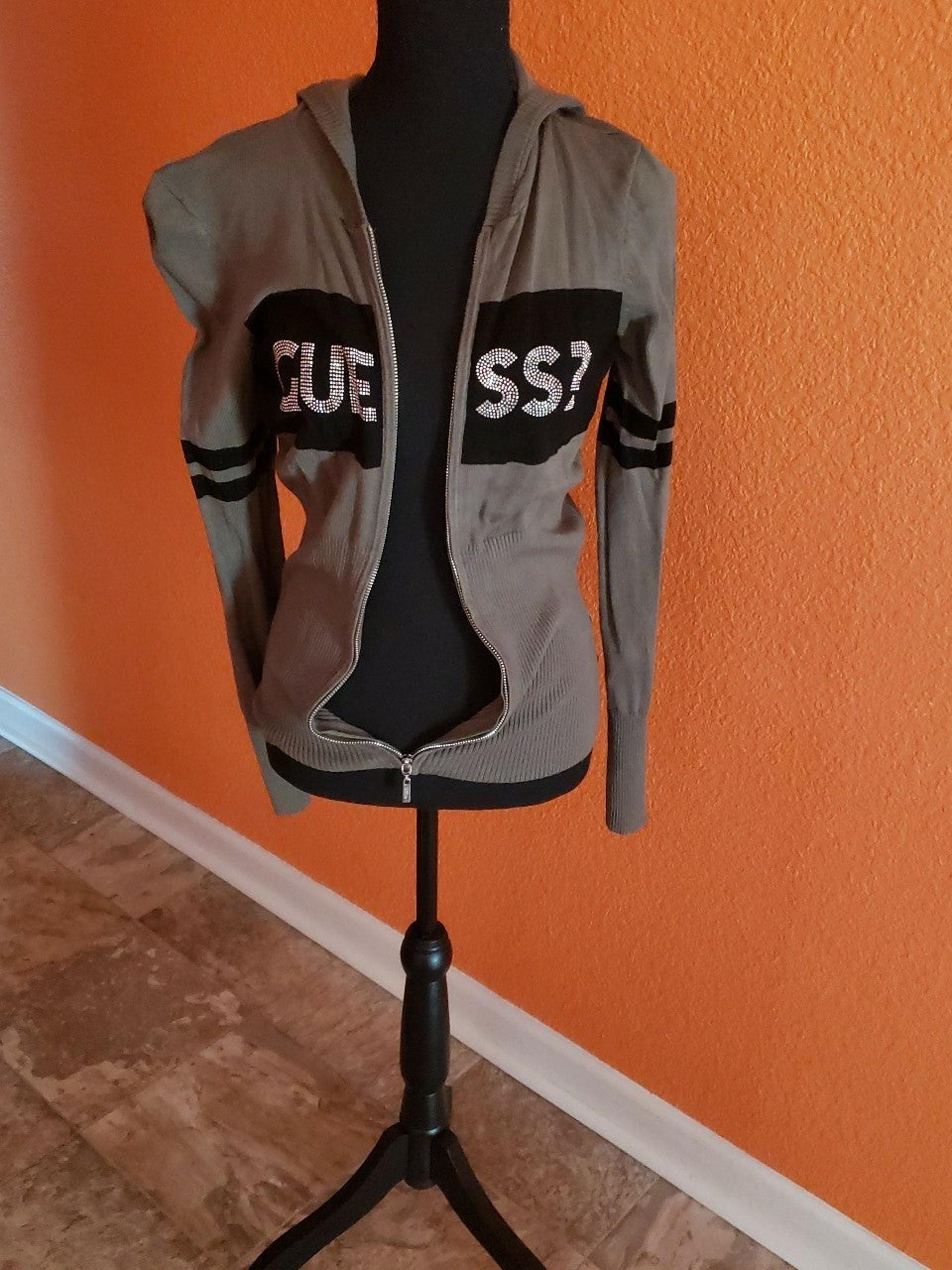 Gently used Junior's Guess zip up hooded  sweater. Size L.