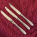 Three Sterling handle flatware dinner knives