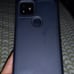 A phone and a white and teal controoler
