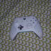 A phone and a white and teal controoler