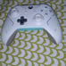 A phone and a white and teal controoler