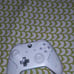 A phone and a white and teal controoler