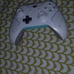A phone and a white and teal controoler