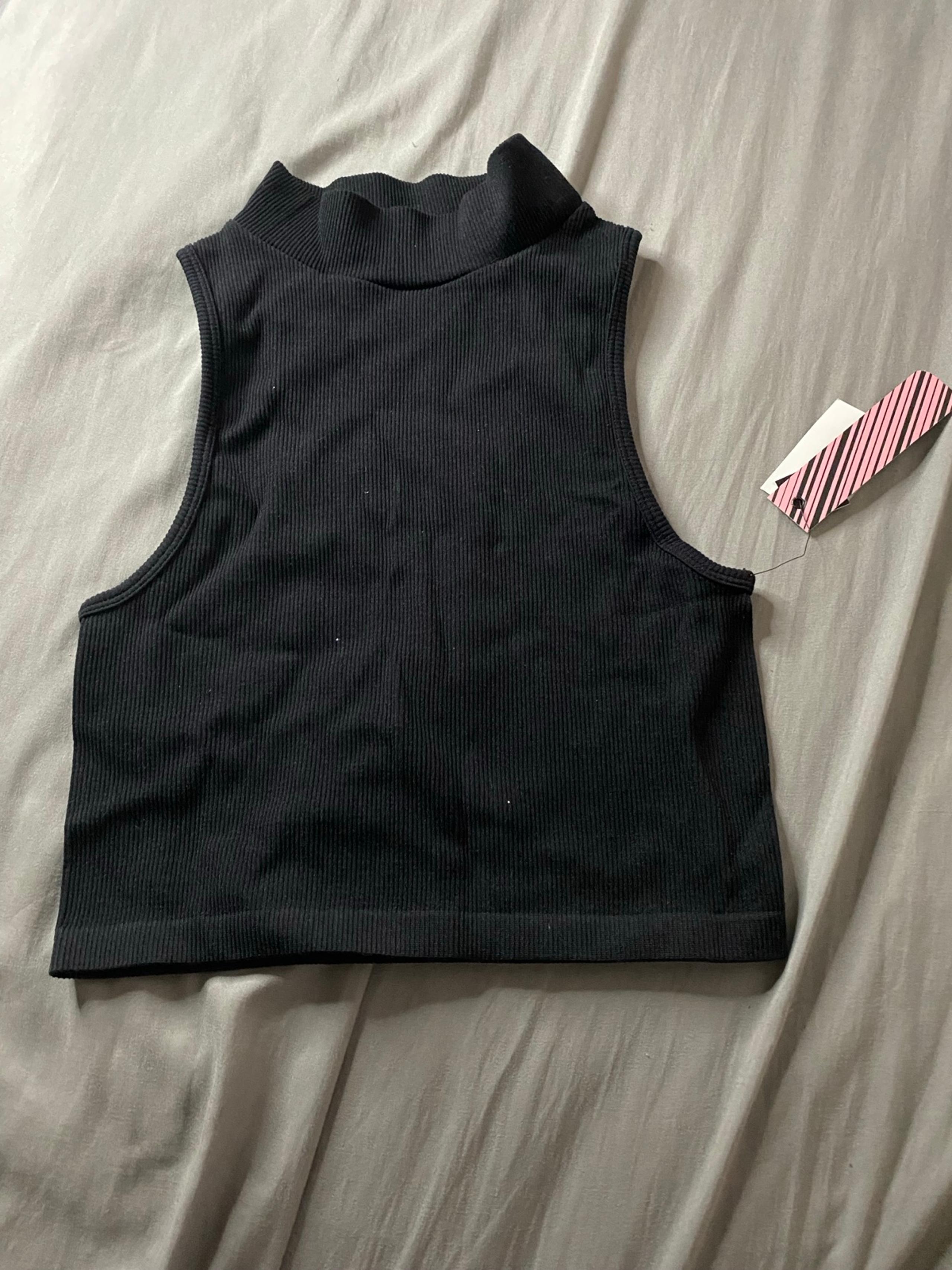 Black sleeveless turtle neck