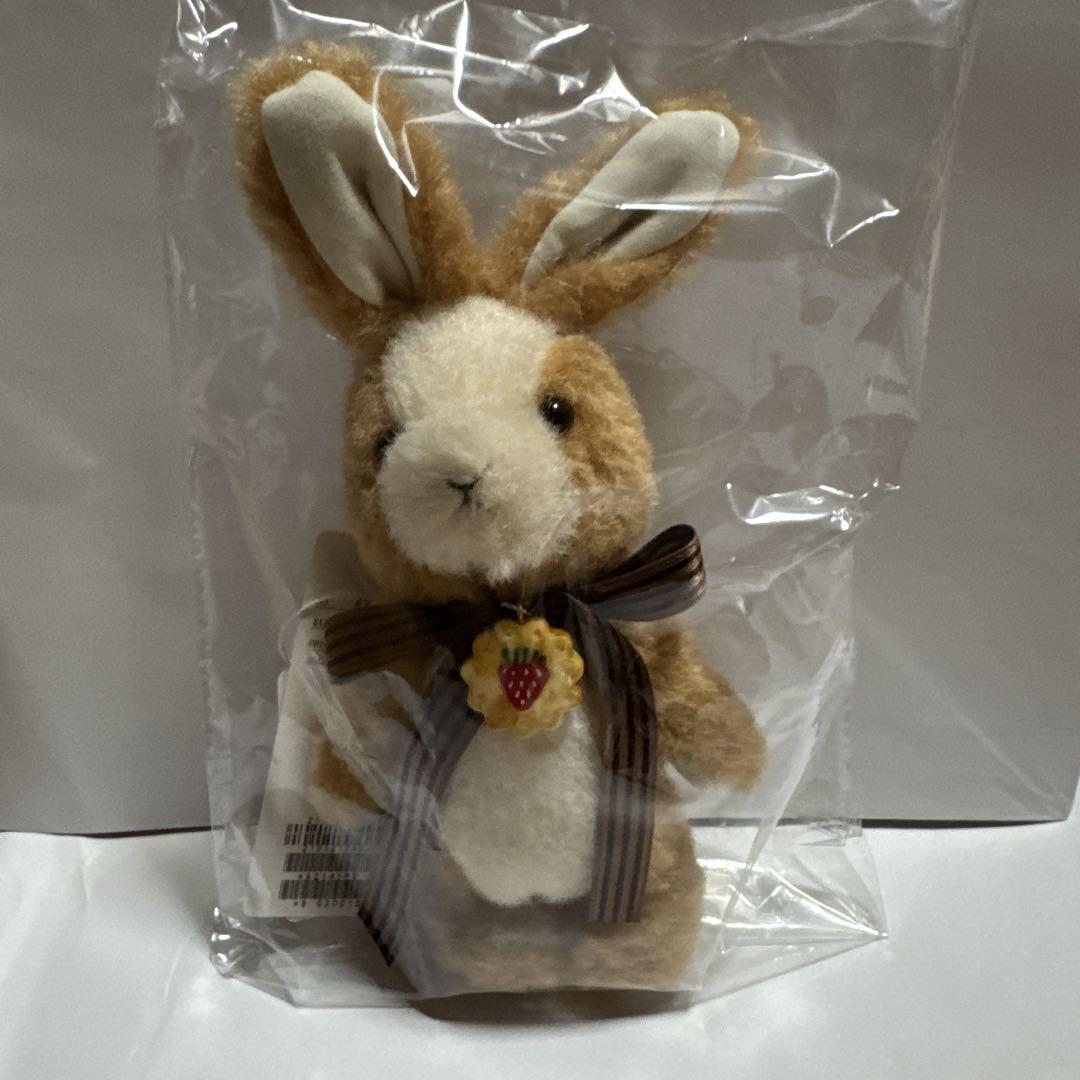 Brand new, unused Pink House Cookie Rabbit plush with a corsage.