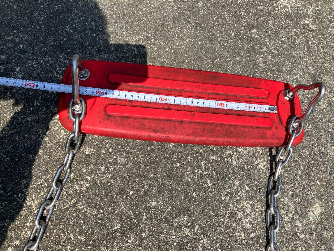 Red plastic swing, approximately 54cm.