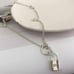 The Lock It Down Long silver necklace with lock and toggle closure