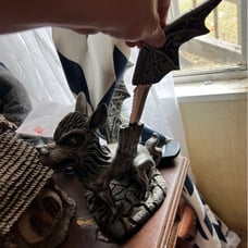 Vintage statue with two knives as wings
