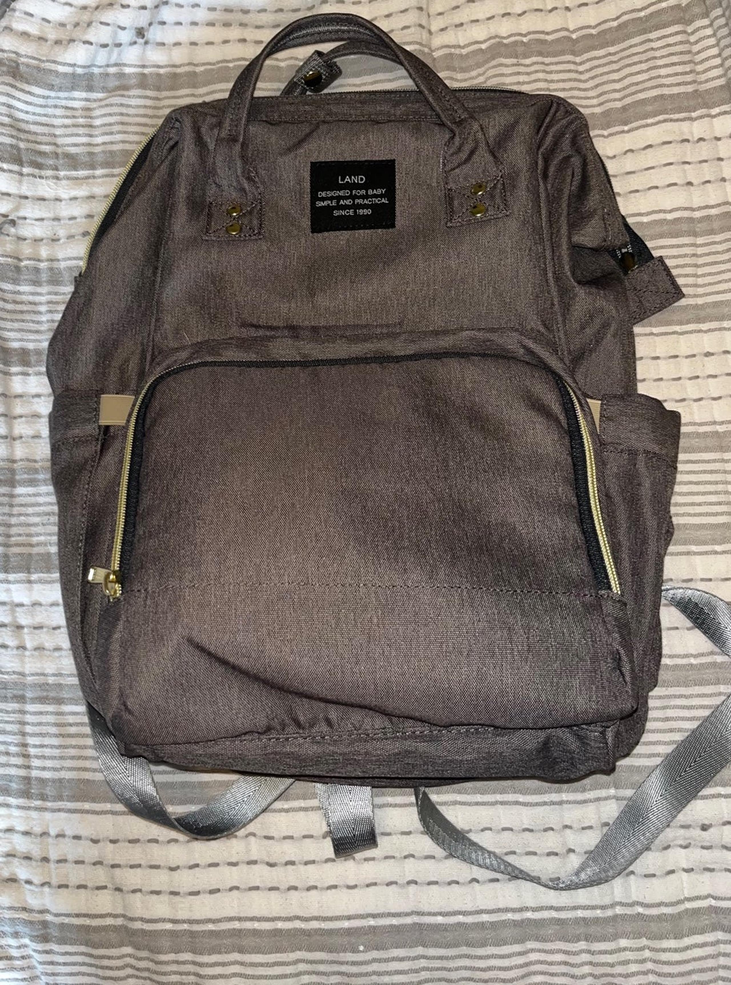 Land Diaper Bag, gray with brass zippers.   Gently used, in almost new condition