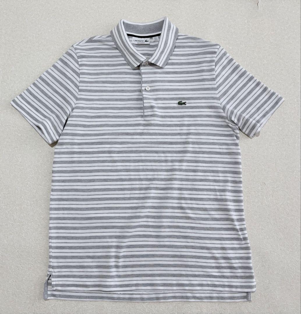 Excellent condition. Size 4. LACOSTE short-sleeved polo shirt. Lacoste. Gray and white stripes.