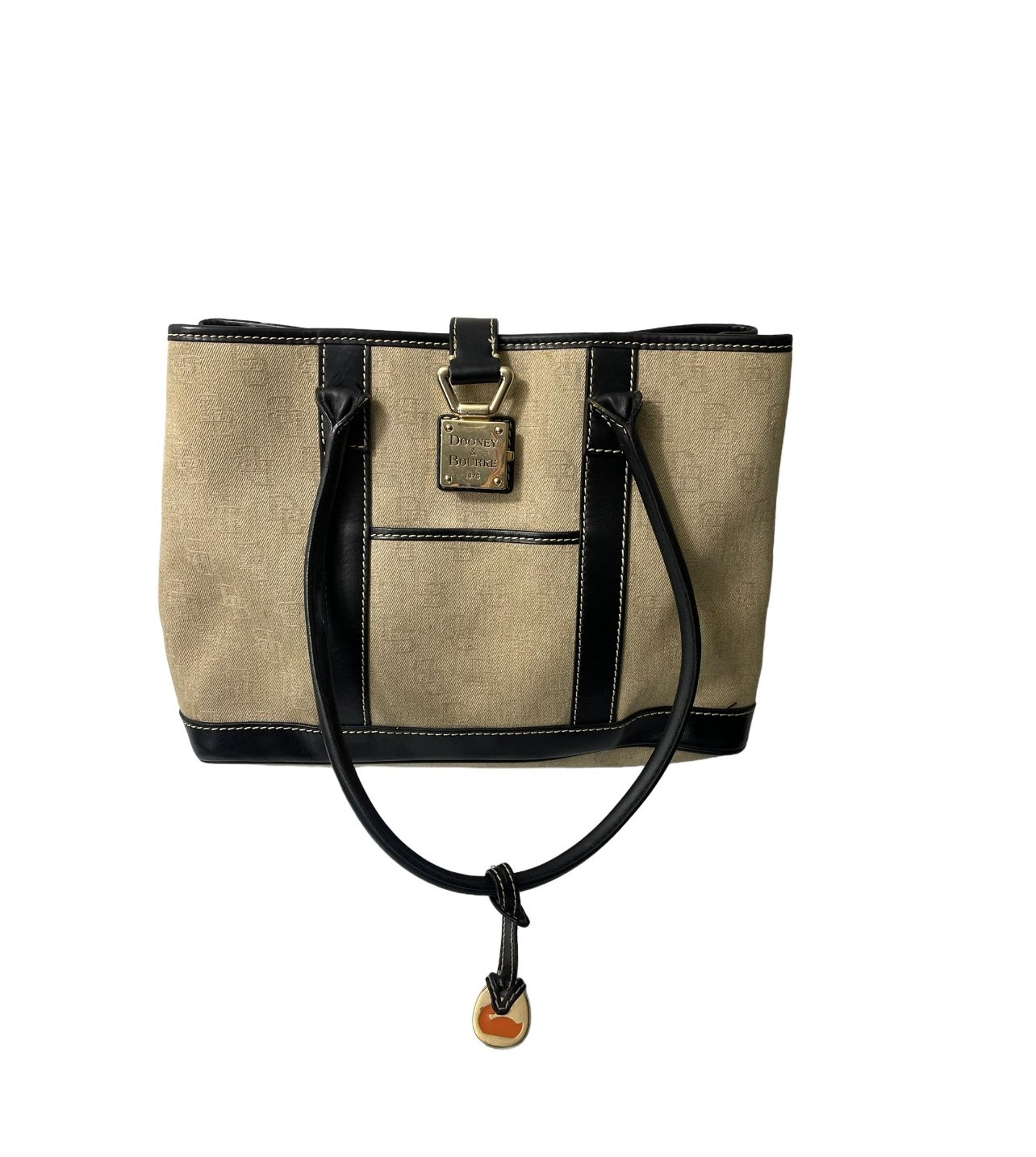 Dooney and Bourke canvas logo tote in beige with dark leather trim and straps.
