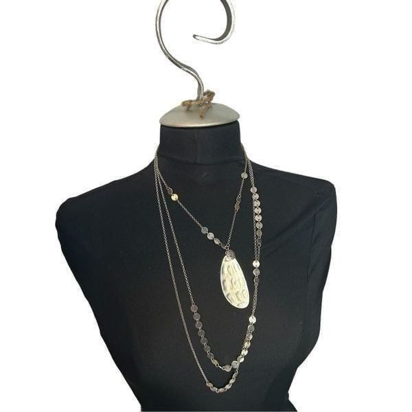 Three chain layered silver necklace mini disc and long oval single centered pend
