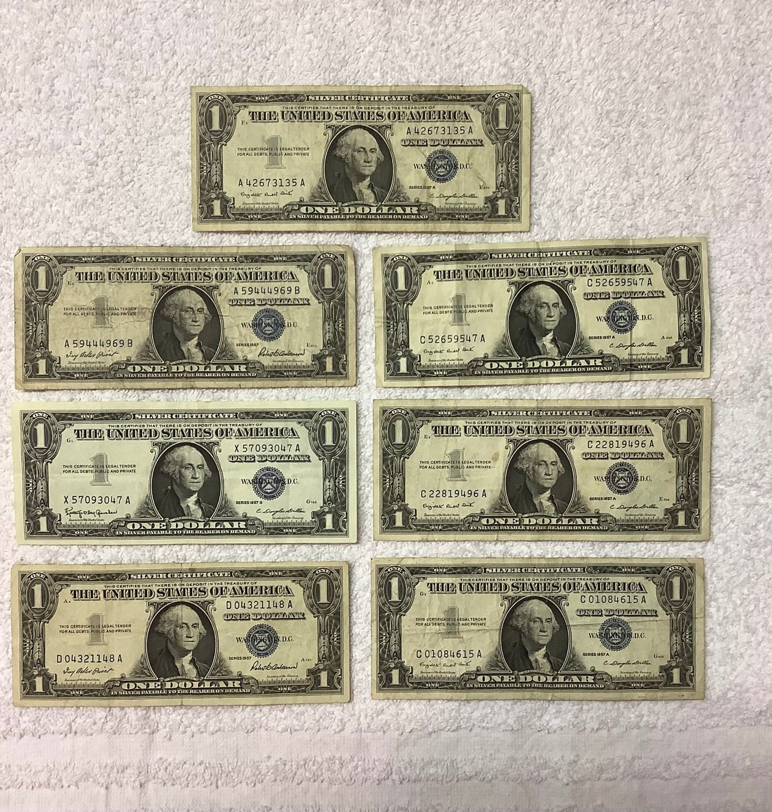 1957 One Dollar Blue Seal Silver Certificate. Lot of 7 bills. Rare.
