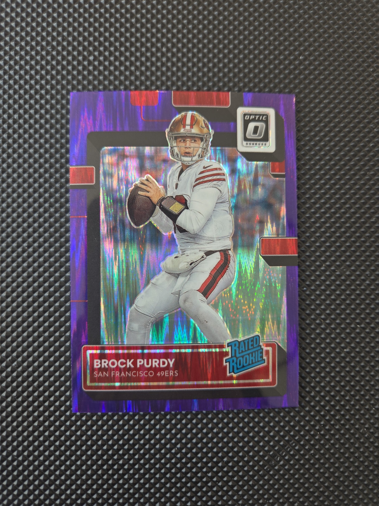 2022 Panini Donruss Optic - Rated Rookie Purple Shock Prizm #277 Brock Purdy