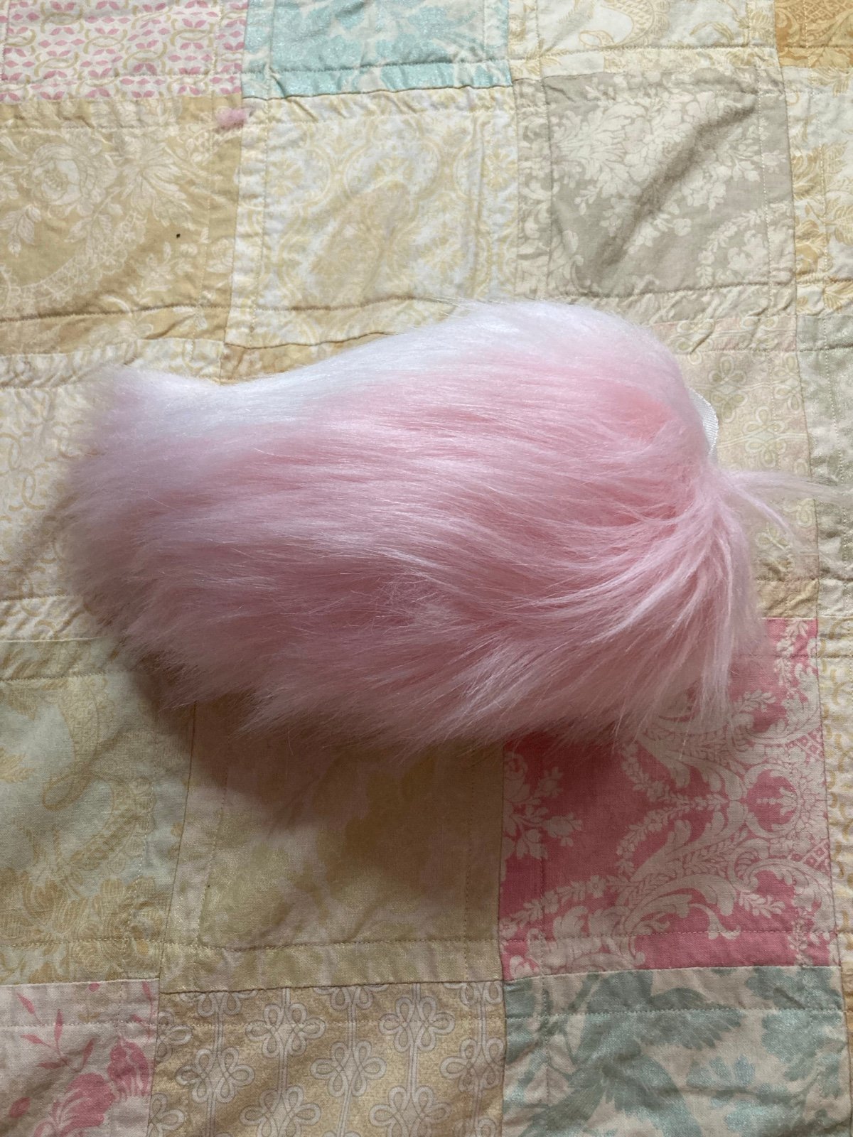 Pink and white fursuit nub tail