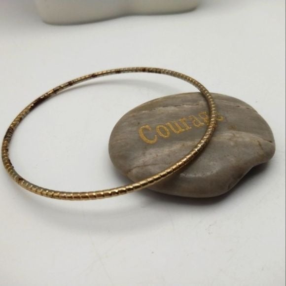 Chicken tracks gold toned round bracelet bangle