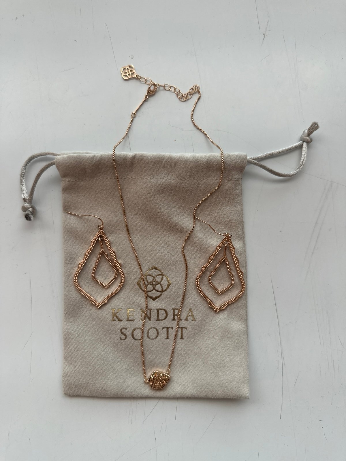 Kendra Scott rose gold necklace and earrings