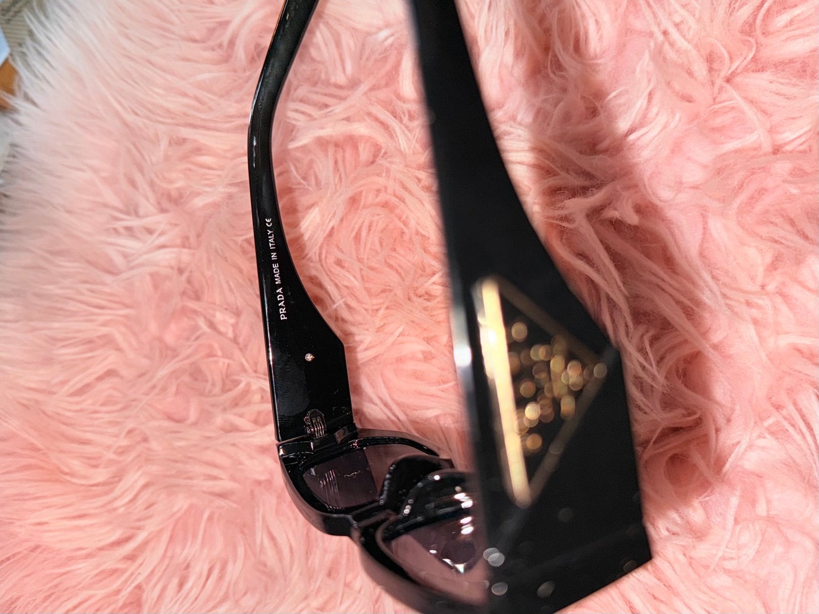 Stylish Prada sunglasses. Sleek black design. Perfect for any occasion