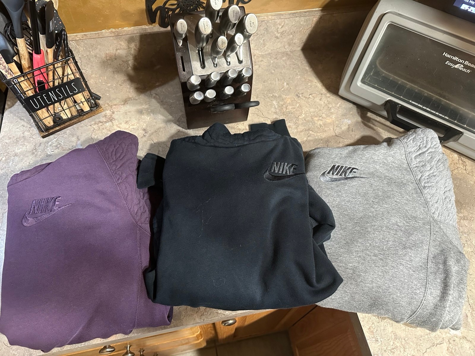 (3) Ladies Nike Sweatshirts. size medium. Great condition black, grey, & purple