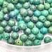 Lot of 62 green 6mm beads, possibly turquoise