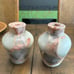 Two vase style candle holders with grapefruit leaves