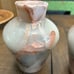 Two vase style candle holders with grapefruit leaves