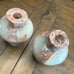 Two vase style candle holders with grapefruit leaves